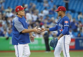Marcus Stroman #6 of the Toronto Blue Jays hands the baseball to manager John Gibbons #5 as he is relieved in the fifth inning during MLB game action against the New York Mets at Rogers Centre on July 4, 2018 in Toronto, Canada. (Photo by Tom Szczerbowski/Getty Images)