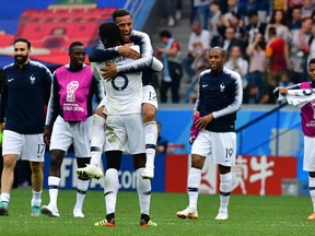 France's midfielder Paul Pogba (2rdL) and France's midfielder Corentin Tolisso celebrate their victory at the end of the Russia 2018 World Cup quarter-final football match between Uruguay and France at the Nizhny Novgorod Stadium in Nizhny Novgorod on July 6, 2018. (MLADEN ANTONOV/AFP/Getty Images)