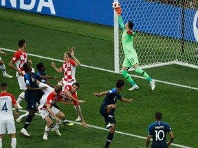 Croatia's forward Mario Mandzukic (C) heads the ball and scores an own goal after France's forward Antoine Griezmann (unseen) shot a free kick during the Russia 2018 World Cup final  at the Luzhniki Stadium in Moscow on July 15, 2018. Adrian Dennis/Getty Images