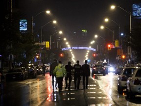 Toronto Police officers work on Danforth St., at the scene of a shooting in Toronto, Ontario, Canada on July 23, 2018.   COLE BURSTON/AFP/Getty Images