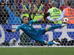 Russia's goalkeeper Igor Akinfeev stops a shot by Spain's to win their knockout round match on July 1. GETTY IMAGES