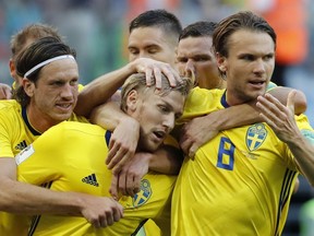 Sweden's Emil Forsberg, center, celebrates with teammates the opening goal during the round of 16 match between Switzerland and Sweden at the 2018 soccer World Cup in the St. Petersburg Stadium, in St. Petersburg, Russia, Tuesday, July 3, 2018. (AP Photo/Efrem Lukatsky)