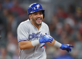 Toronto Blue Jays' Devon Travis celebrates hitting a grand slam against the Atlanta Braves. (AP Photo/Todd Kirkland)