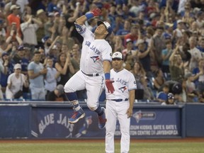 Toronto Blue Jays' Yangervis Solarte celebrates rounding third base after hitting a three run home run against the New York Mets in the seventh inning of their interleague MLB baseball game in Toronto on Tuesday, July 3, 2018.