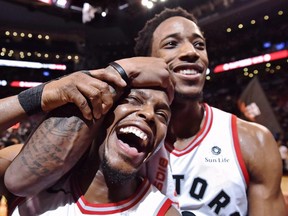 Toronto Raptors' Kyle Lowry, left, and DeMar DeRozan celebrate after defeating the Milwaukee Bucks in NBA basketball action in Toronto on Monday, January 1, 2018.  THE CANADIAN PRESS/Frank Gunn