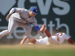 Toronto Blue Jays' Aledmys Diaz, left, tries to tag Boston Red Sox 's Mookie Betts (50) as Betts steals second base in the seventh inning of a baseball game, Sunday, July 15, 2018, in Boston.