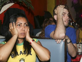 Brazilian soccer fans react after losing to Belgium in the 2018 FIFA World Cup at the Lula Lounge on Dudas St W, in Toronto on Friday July 6, 2018. (Veronica Henri/Toronto Sun/Postmedia Network)