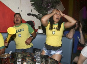 Brazilian soccer fans react after losing to Belgium in the 2018 FIFA World Cup at the Lula Lounge on Dudas St W, in Toronto on Friday July 6, 2018. (Veronica Henri/Toronto Sun/Postmedia Network)