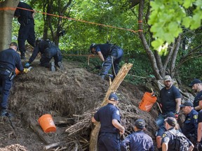 Members of the Toronto Police Service excavate the back of property along Mallory Cres. in Toronto after confirming they have found human remains during an investigation in relation to alleged serial killer Bruce McArthur on Thursday, July 5, 2018. THE CANADIAN PRESS/Tijana Martin