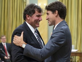 Prime Minister Justin Trudeau shakes hands with Dominic LeBlanc, Minister of Intergovernmental and Northern Affairs and Internal Trade, during a swearing in ceremony at Rideau Hall in Ottawa on Wednesday, July 18, 2018.