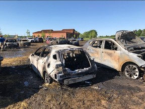 Burned-out vehicles are seen after a fire spread through a hayfield being used as a parking lot for the Niagara Lavender Festival on Sunday, July 8, 2018 in Niagara-on-the-Lake. (NOTLfiredept/Twitter)