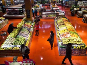 People shop at a Loblaws store in Toronto on May 3, 2018.