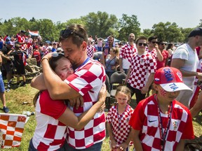 Croatian fan Mijo Despot kisses his wife Julie, following Croatia's loss to France after watching the World Cup Final on the big screen at Croatian Parish Park in Mississauga, Ont. on Sunday. (Ernest Doroszuk/Toronto Sun)