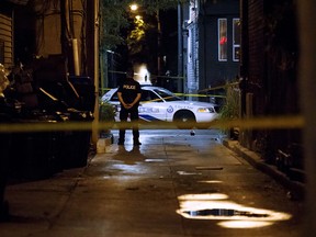 In this file photo taken on July 23, 2018, a Toronto police officer stands watch at Danforth St. at the scene of a shooting in Toronto. (Getty Images)