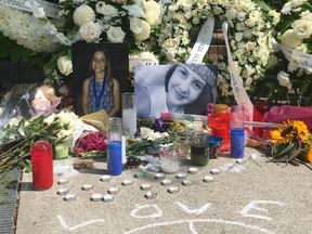Julianna Kozis, 10, (left) and Reese Fallon, 18, whose images are seen here at a memorial on the Danforth, were killed and 13 others wounded when a gunman went on a shooting rampage in Greektown on Sunday, July 22, 2018. (Chris Doucette/Toronto Sun/Postmedia Network)