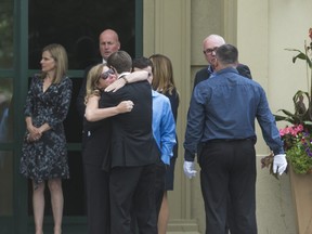 Loved ones embrace during Monday's funeral for Danforth shooting victim Reese Fallon at Highland Funeral Home at Scarborough (Ernest Doroszuk/Toronto Sun)