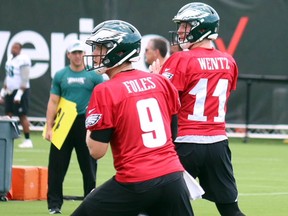 Nick Foles and Carson Wentz drop back to throw during training camp Thursday. (JOHN KRYK/Postmedia Network)