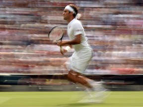 Switzerland's Roger Federer runs to play a return against Slovakia's Lukas Lacko during their men's singles second round match on the third day of the 2018 Wimbledon Championships at The All England Lawn Tennis Club in Wimbledon, southwest London, on July 4, 2018.