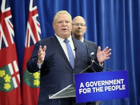 Ontario Premier Doug Ford(L) with Municipal and Housing Minister Steve Clark on Friday July 27, 2018 in Toronto. The PC government will introduce legislation to cut Toronto city council seats from 47 to 25 and eliminate regional chair elections in elections in Peel, York, Niagara and Muskoka. (Veronica Henri/Toronto Sun/Postmedia Network)