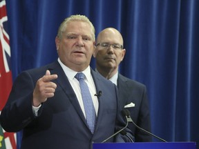 Ontario Premier Doug Ford(L) with Municipal and Housing Minister Steve Clark on Thursday July 26, 2018 in Toronto. The PC government will introduce legislation to cut Toronto city council seats from 47 to 25 and eliminate regional chair elections in elections in Peel, York, Niagara and Muskoka. (Veronica Henri/Toronto Sun/Postmedia Network)