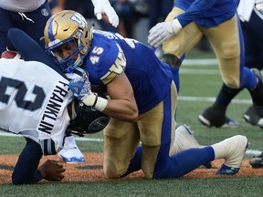 Winnipeg Blue Bombers LB Jovan Santos-Knox sacks Toronto Argonauts QB James Franklin Friday night. (Kevin King/Postmedia Network)