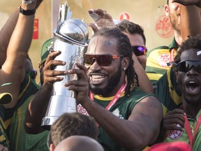 Vancouver Knights' Chris Gayle holds up trophy after his team defeated the West Indies B Team in their final of the Global T20 Canada cricket tournament in King City, Ont., on  July 15, 2018. (FRED THORNHILL/The Canadian Press)