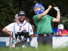 Canadian Adam Hadwin attempts to practice his tee shot with goalie mask that was used as the tee blocks on the seventh hole during the pro-am ahead of the Canadian Open at the Glen Abbey Golf Club in Oakville Ont., on Wednesday. Hadwin never ended up hitting his tee shot with the mask. THE CANADIAN PRESS/Nathan Denette