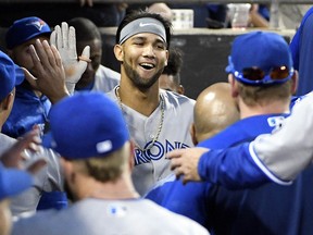 Lourdes Gurriel Jr. of the Toronto Blue Jays is greeted in the dugout after hitting a home run against the Chicago White Sox on July 27, 2018 at Guaranteed Rate Field in Chicago. (David Banks/Getty Images)