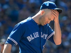 Toronto Blue Jays starting pitcher J.A. Happ walks up the mound after he gave up back to back home runs to New York Yankees' Brett Gardner and teammate Aaron Judge, not seen, during first inning American League MLB baseball action in Toronto on Saturday, July 7, 2018.