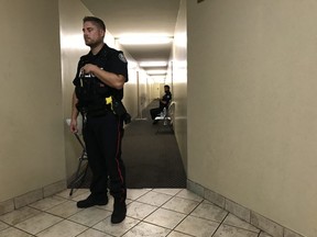 Police guard a seventh-floor apartment at 43 Thorncliffe Park Dr. in Toronto, Ont. in the Millwood Rd. and Overlea Blvd. area, awaiting the arrival of a search warrant in connection with Sunday's mass shooting on Danforth Ave. (Stan Behal/Toronto Sun)