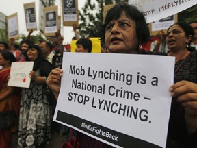 Indians hold placards and shout slogans during a protest against mob attacks in Ahmadabad, India, Monday, July 23, 2018. (AP Photo/Ajit Solanki)