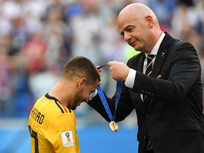 FIFA president Gianni Infantino (right) presents the bronze medal to Belgium's forward Eden Hazard following their win in the Russia 2018 World Cup play-off for third place football match between Belgium and England at the Saint Petersburg Stadium in Saint Petersburg yesterday. (Getty Images)