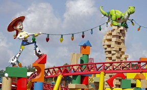 Jessie pulls on a string of giant lights tangled around Rex the dinosaur at Toy Story Land in Disney’s Hollywood Studios at Walt Disney World in Lake Buena Vista, Fla. (AP Photo/John Raoux)
