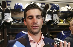 Maple Leafs centre John Tavares speaks to the media at his locker after signing a seven-year, $77 million contract in Toronto on Sunday, July 1, 2018.