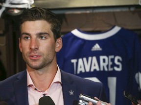 Toronto Maple Leafs John Tavares speaks to the media at his locker after signing on for a seven-year $77 million contract on Sunday July 1, 2018.