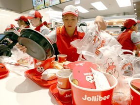 Employees serve up food for a newly opened Jollibee store in Mississauga on Friday July 20, 2018. Dave Abel/Toronto Sun/Postmedia Network