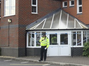 A police officer stands outside Amesbury Baptist Centre where British police have declared a "major incident" after two people were exposed to an unknown substance, in Amesbury, England, Wednesday July 4, 2018. (AP Photo/Rod Minchin)