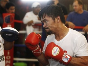Philippine senator and boxing champion Manny Pacquiao trains at a press preview in Kuala Lumpur, Malaysia, Wednesday, July 11, 2018. (AP Photo/Yam G-Jun)