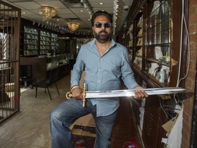 Baldev Manjania poses with his sword at New Rana Jewellers, on Airport Rd. near Derry Rd., in Mississauga, Ont.  Manjania used the sword to chase off alleged thieves following a robbery where a van backed into the store he co-owns, smashing the front. (Ernest Doroszuk/Toronto Sun)
