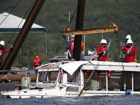 The duck boat that sank in Table Rock Lake in Branson, Mo., is raised on July 23, 2018. (Nathan Papes/The Springfield News-Leader via AP)