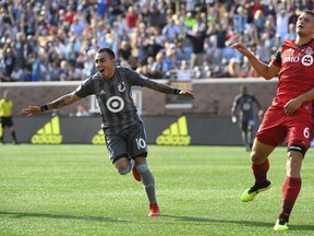 Minnesota United midfielder Miguel Ibarra (10) celebrates his first-half goal, next to Toronto FC's Nick Hagglund during an MLS soccer match Wednesday, July 4, 2018, in Minneapolis. (Aaron Lavinsky/Star Tribune via AP)