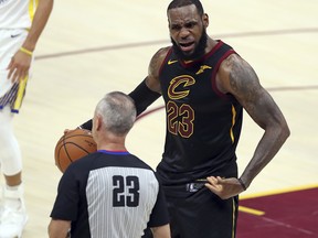 Cleveland Cavaliers' LeBron James argues a call with referee Jason Phillips during the first half of Game 4 of basketball's NBA Finals against the Golden State Warriors(AP Photo/Carlos Osorio)