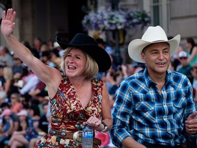 Alberta Premier Rachel Notley, left, and finance minister Joe Ceci, take part in during the Calgary Stampede parade in Calgary, Friday, July 6, 2018.
