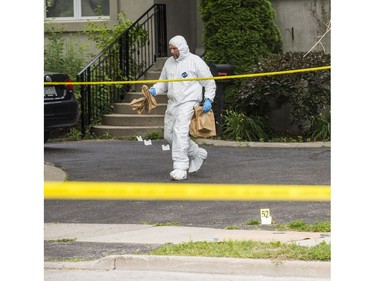 Halton Regional Police Forensic Identification officers at the scene of a homicide in the area of Rebecca St., east of Dorval Dr. in Oakville, Ont. on Saturday July 14, 2018. Ernest Doroszuk/Toronto Sun/Postmedia