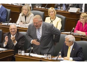 Ontario Premier Doug Ford takes a bow after bragging about his election victory during Question Period at the Ontario Legislature in Toronto on Monday, July 30, 2018. (Chris Young/The Canadian Press)
