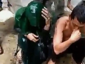 A cheating Indonesian couple are captured by a mob and have buckets of sewage poured over their heads.