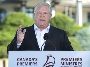 Ontario Premier Doug Ford talks with reporters as the Canadian premiers meet in St. Andrews, N.B. on Thursday, July 19, 2018.