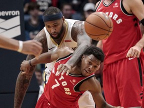 Pelicans centre DeMarcus Cousins (back) fouls Raptors guard Kyle Lowry last season. Cousins joined the already-stacked Warriors on a one-year deal.  Scott Threlkeld/AP