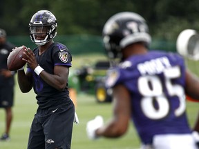 Baltimore Ravens quarterback Lamar Jackson, left, runs a drill during a training camp practice at the team's headquarters, Monday, July 23, 2018, in Owings Mills, Md. (AP Photo/Patrick Semansky)