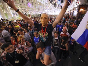 A man wearing a facemark of Russian President Vladimir Putin waves after the final match between France and Croatia at the 2018 soccer World Cup in Moscow, Russia, Sunday(AP Photo/Dmitri Lovetsky)